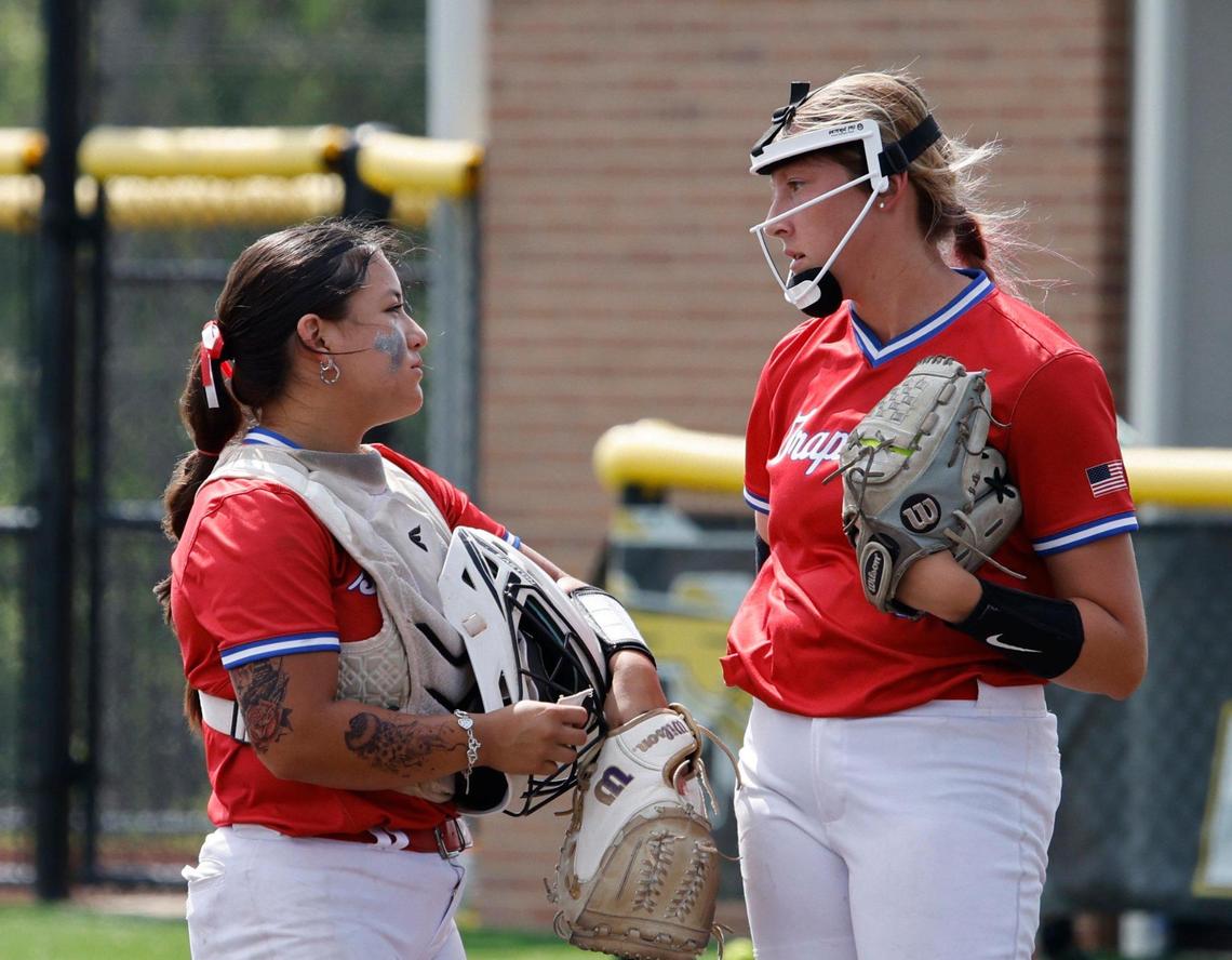 Grapevine catcher Ashley Johnson (8) and pitcher Bella MacMahon (9) talk over the situation during game 2 of the UIL softball semifinal 5A D2 playoffs at The Rabbit Hole in Forney, Texas, Saturday, May 24, 2025.