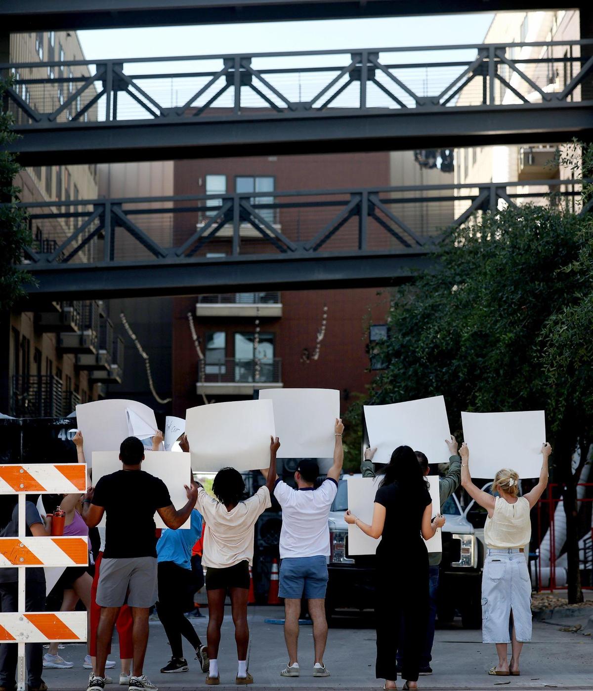Residents of The Cooper protest a lack of communication from the management and owners of the south Fort Worth apartment complex on July 7. Residents, who had not been able to occupy their residences for weeks following a six-alarm fire, were demanding to speak with management.