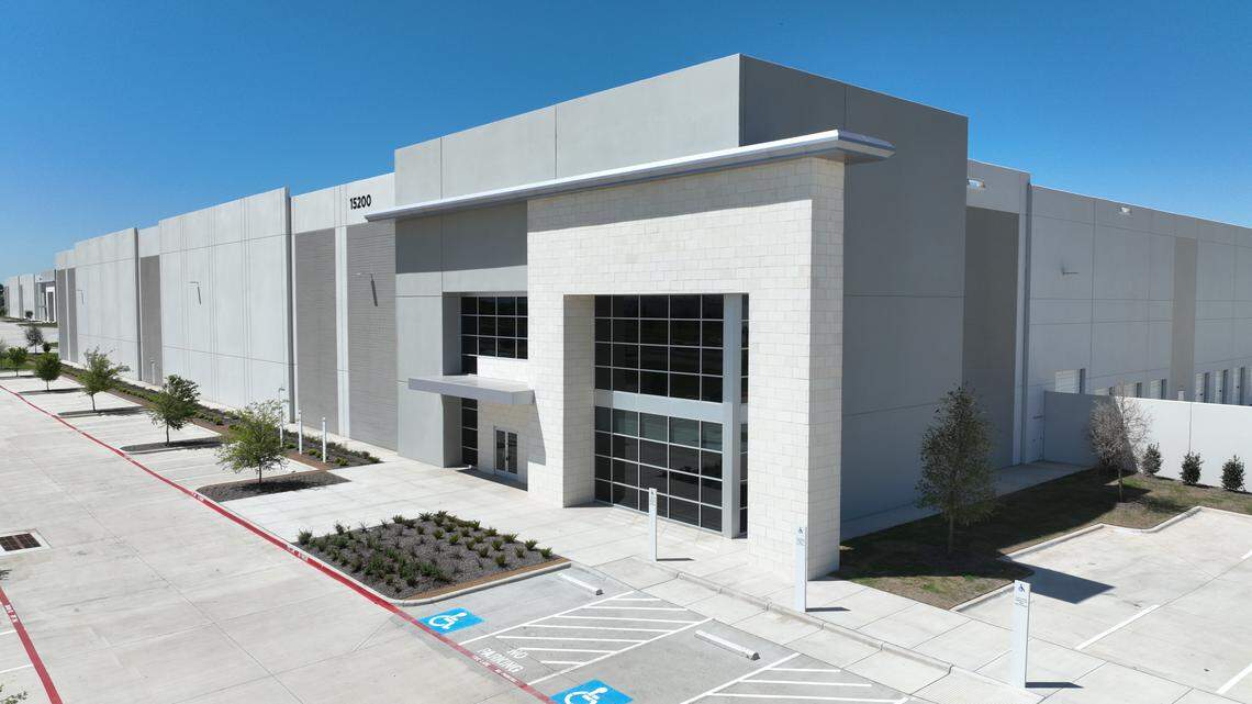 A rendering of a generic boxy building in an office park