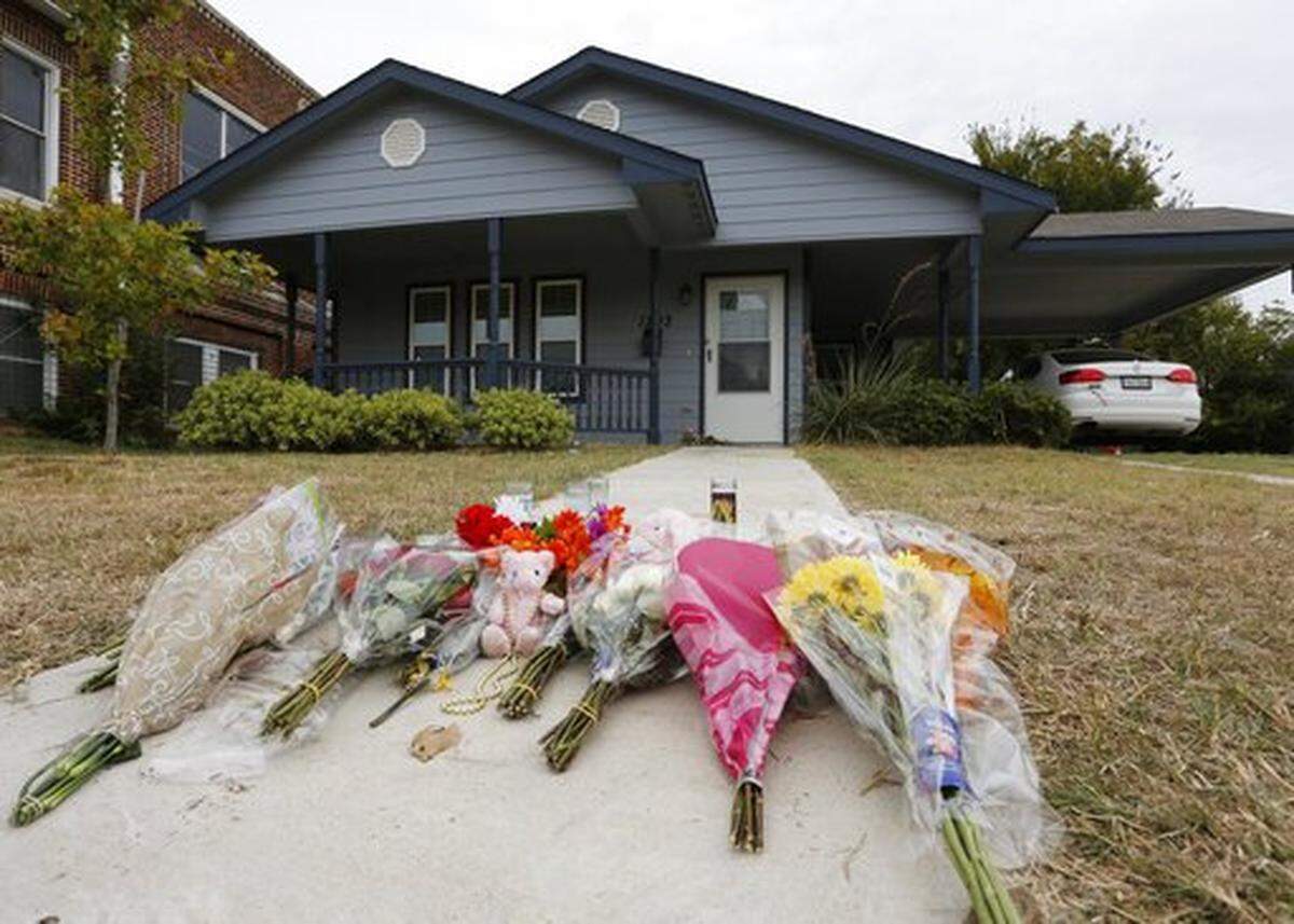 FILE - In this Monday, Oct. 14, 2019 photo, flowers lie on the sidewalk in front of the house in Fort Worth, Texas, where white Fort Worth police officer Aaron Dean shot and killed Atatiana Jefferson, a Black woman, through a back window of her home. Dean was not heard identifying himself as police on the bodycam video, and Police Chief Ed Kraus has said there was no sign Dean or the other officer who responded knocked on the front door. Dean resigned and is charged with murder.