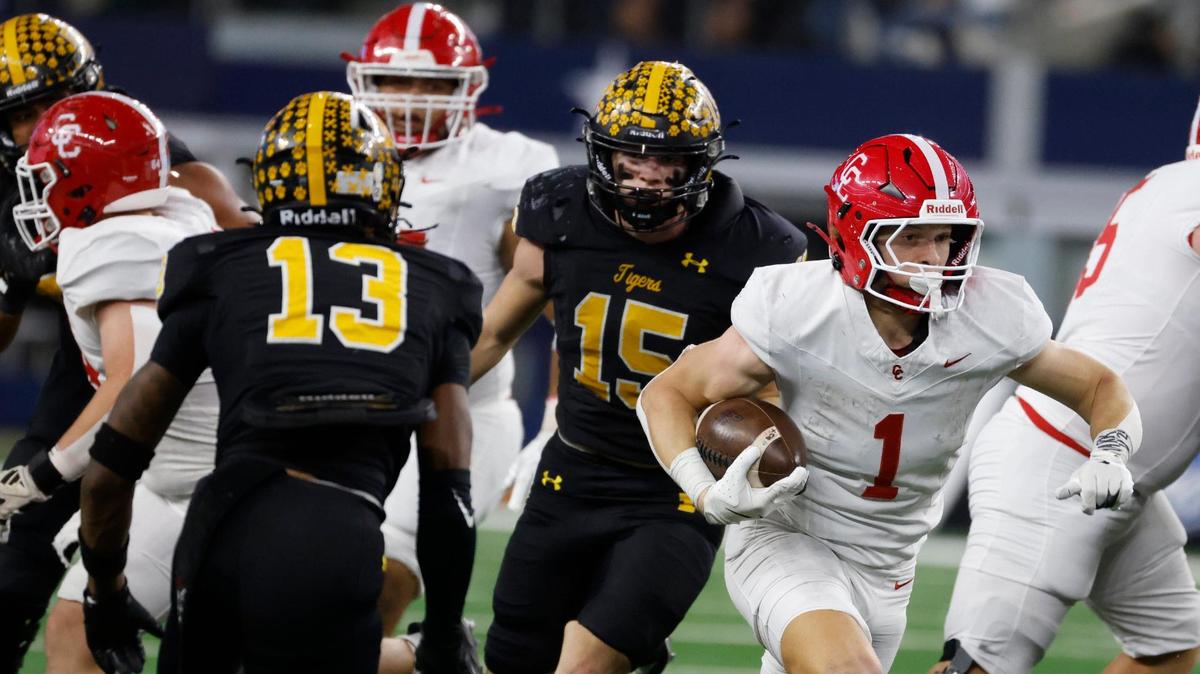 Columbus running back Grayson Rigdon (1) slices through the defense of defensive backs Kayland Davis (13) and Evan Loper (15) for a gain during the UIL 3A D1 State Championship football game at AT&T Stadium in Arlington, Texas, Thursday, Dec. 19, 2024.