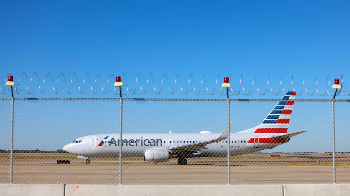 In an archive photo, an American Airlines airplane taxis to a runway at Dallas-Fort Worth International Airport. A North Texas man who is accused of assaulting a passenger and threatening a flight attendant while flying from Wichita to D.C. said he wanted to speak to President Trump, according to a warrant.