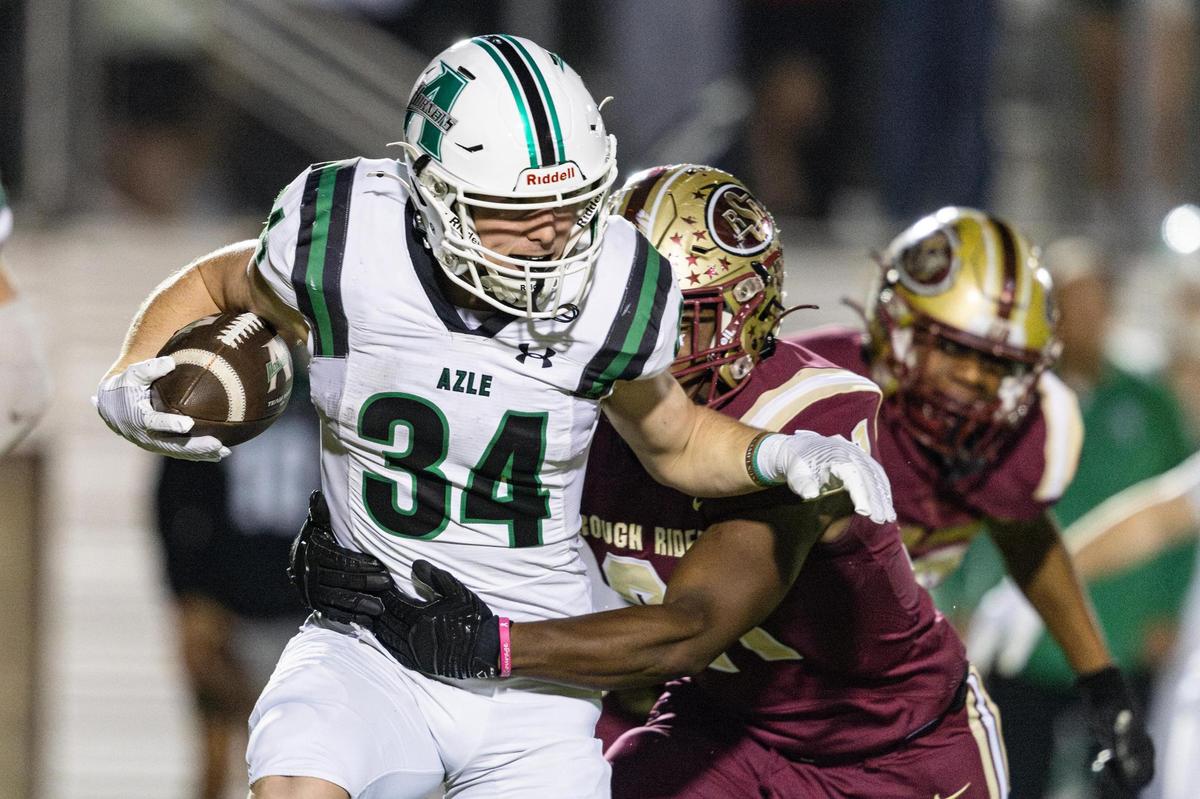 Azle running back Hagen Hughes (34) is tackled by Saginaw linebacker Najae Nicholson (21) in the first half of an Class 5A Division I playoffs game between Saginaw and Azle at Rough Rider Stadium in Saginaw on Friday, Nov. 15, 2024.