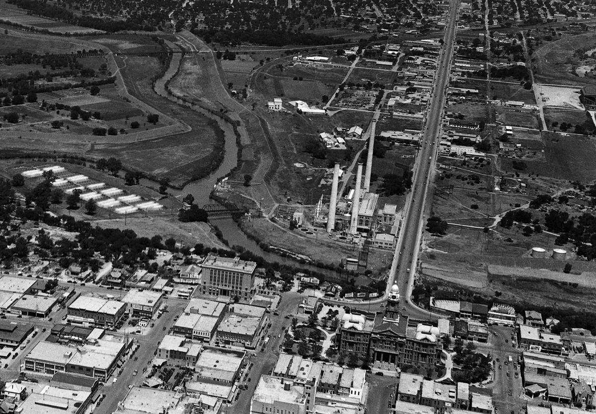 An aerial view of the north edge of downtown Fort Worth in May 1939, showing the North Main Street bridge and the former Fort Worth Power & Light plant along the river.