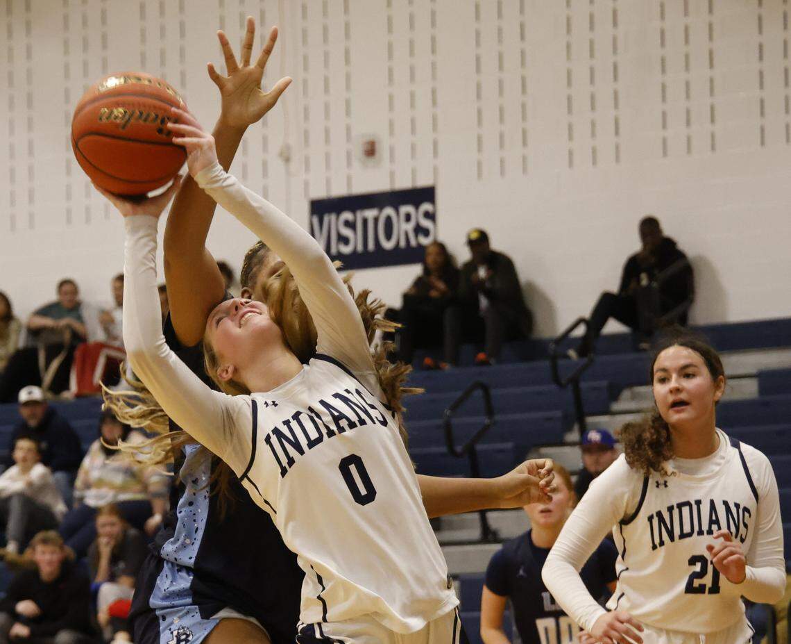 Keller guard Lila Russell (0) is fouled by L.D. Bell point Madi Capers (23) during the first half of a UIL girls basketball game between L.D. Bell and Keller at Keller High School in Keller, Texas, Friday Jan. 16, 2026