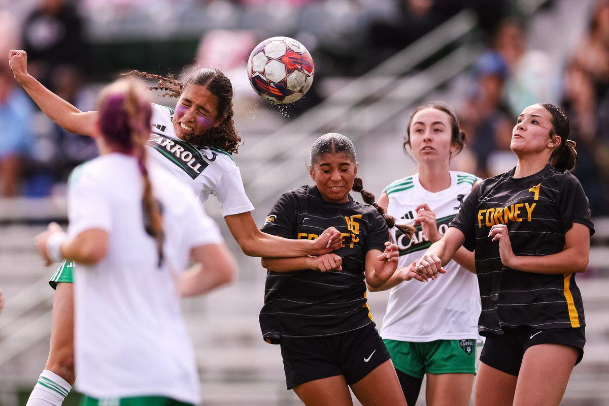 Southlake Carroll striker Mariana Auns (23) attempts to head the ball as two Forney defenders close in on the ball in a UIL Class 6A Division 2 girls soccer state semifinal on Saturday, April 4, 2026, at Memorial Stadium in Mesquite, Texas.