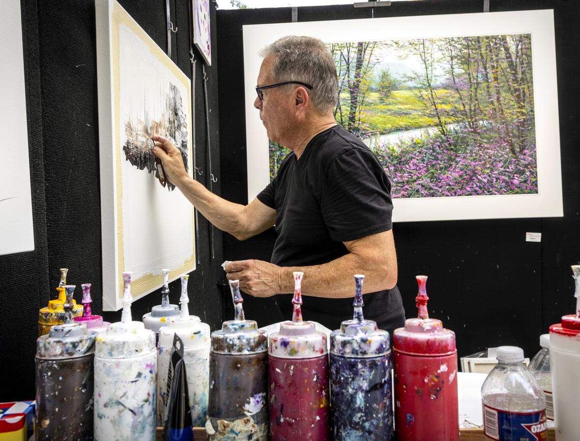 An artist at last year's festival showing their work by creating a painting live at the fine art festival at Southlake Town Square.