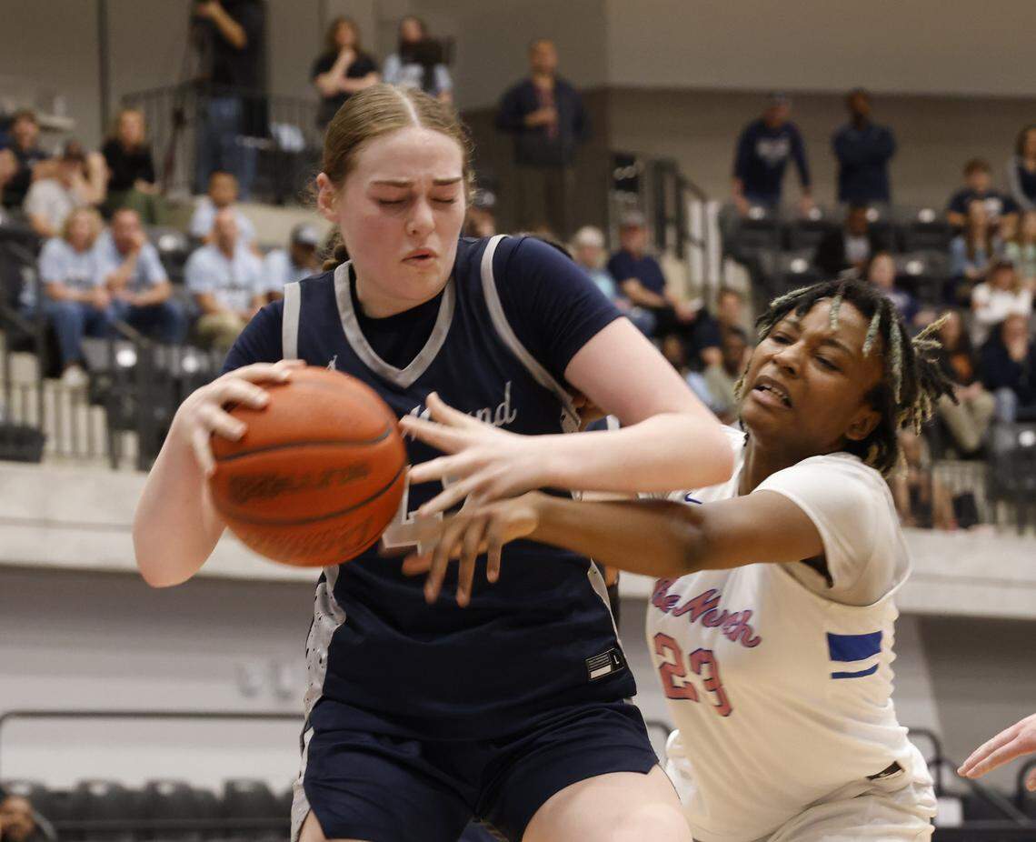 North Crowley forward Mecca Crawford (23) reaches around Flower Mound guard Lorelei Ebert (42) during the first half of a UIL Class 6A Division I girls regional final basketball playoff game at Arlington ISD Athletics Center in Arlington, Texas, Friday Feb. 27, 2026.