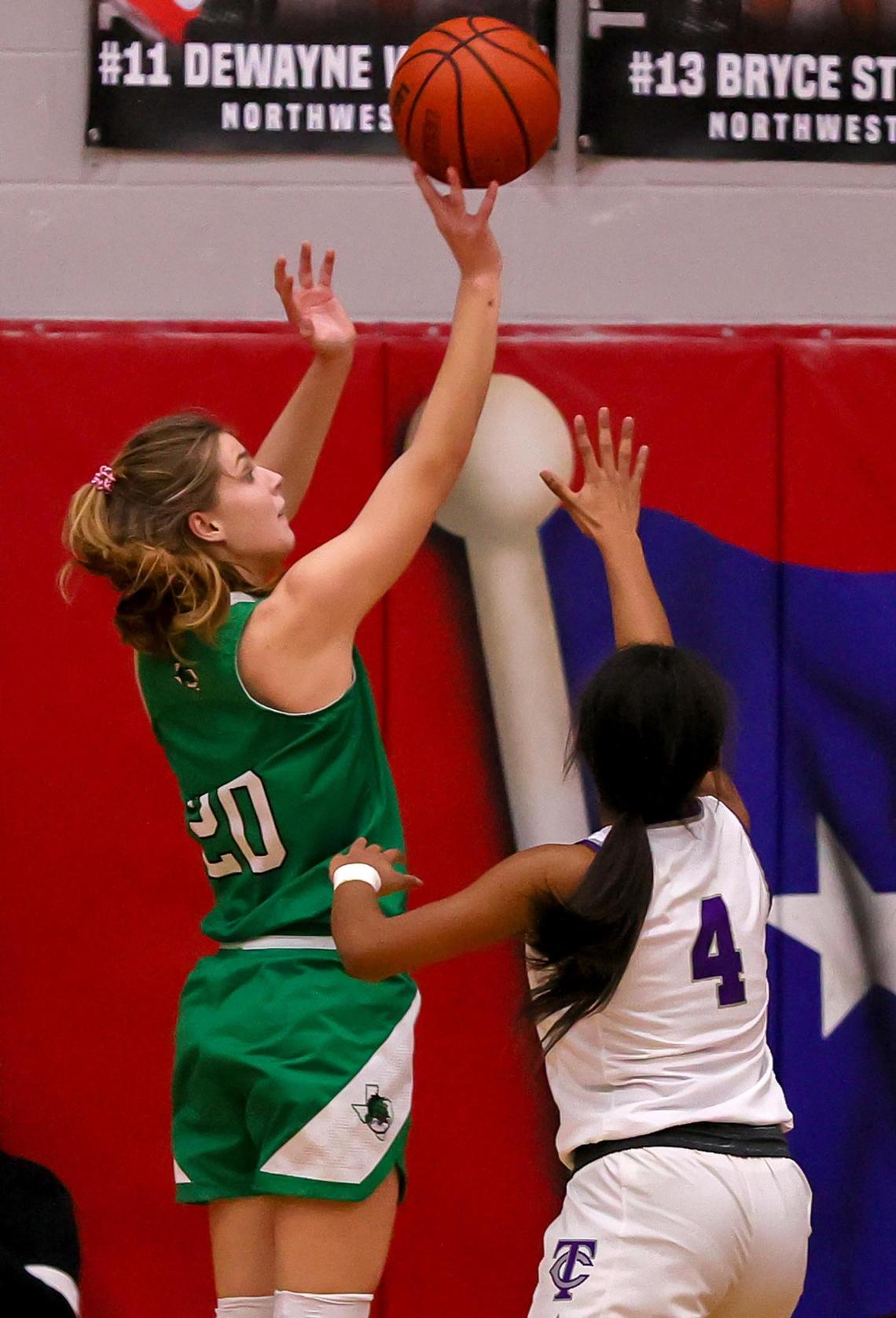 Southlake Carroll guard Camryn Tade (20) gets off a shot over Keller Timber Creek guard Mia Topping (4) during the first half of a 6A Region I Regional Quarter-Finals Girls Basketball playoff game played on Thursday, February 25, 2021 at Justin Northwest High School. (Steve Nurenberg Special to the Star-Telegram)