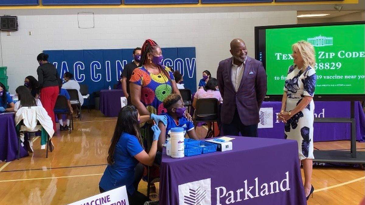 Emmitt Smith joined First Lady Jill Biden at a COVID-19 vaccination clinic Tuesday at Conrad High School in Dallas.
