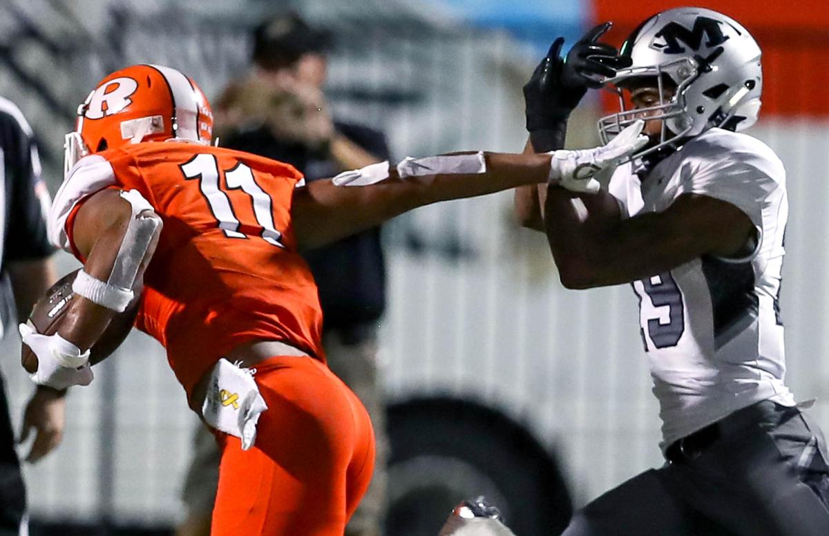 Rockwall wide receiver Jaxon Smith-Njigba (11) gives a stiffarm to Arlington Martin defensive back Placide Djungu-Sungu (19) during the first half, Friday night, September 20, 2019 played at Wilkerson-Sanders Stadium in Rockwall, TX