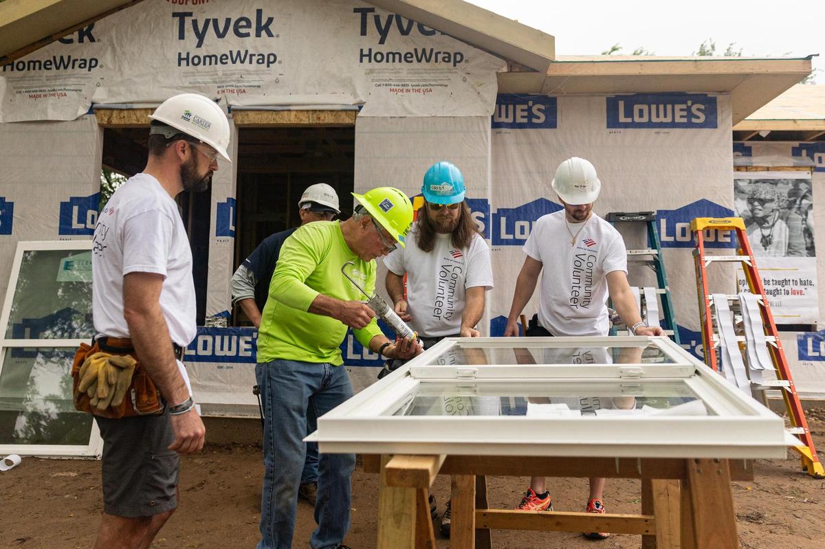 Construction workers and community volunteers begin to construct the first home built as part of the Opal Lee 100 Legacy Home initiative at the Historic Rosedale neighborhood in Fort Worth on Friday, April 25.