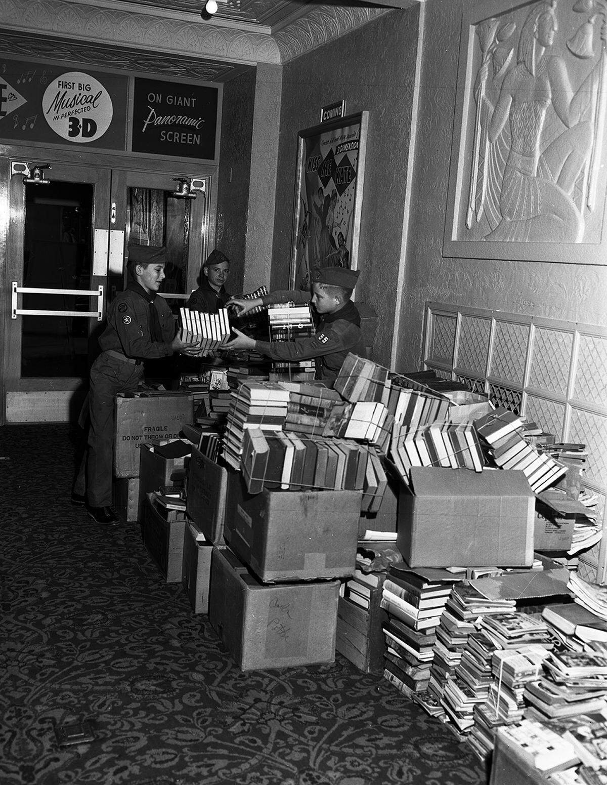 Nov. 14, 1953: Members of Boy Scout Troop 55 stack a portion of the 5,000 volumes contributed to the Douglas E. Humphrey Memorial Library at a special book matinee at the Worth Theater. Left to right are Billy Koci, 12, Paul Polanovich, 14, and Morris Oldham, 12.
