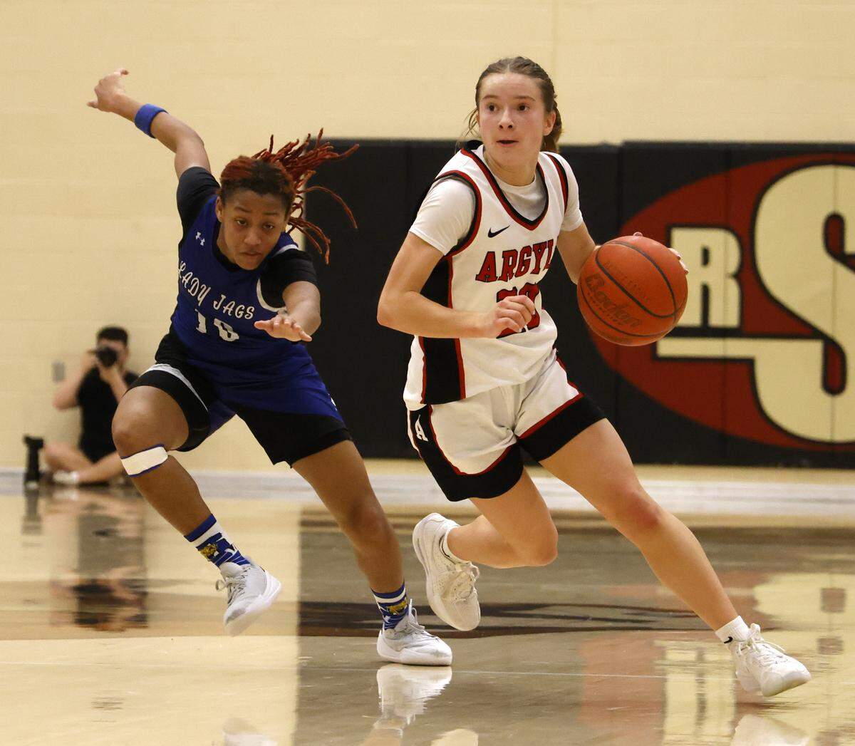 Argyle guard Lexi Ehrhardt (20) brings the ball down court ahead of Mansfield Summit guard Kyleigh Smith (10) during the second half of a UIL Class 5A DII girls playoff basketball game at Saginaw High School in Saginaw, Texas, Thursday Feb. 19, 2026.