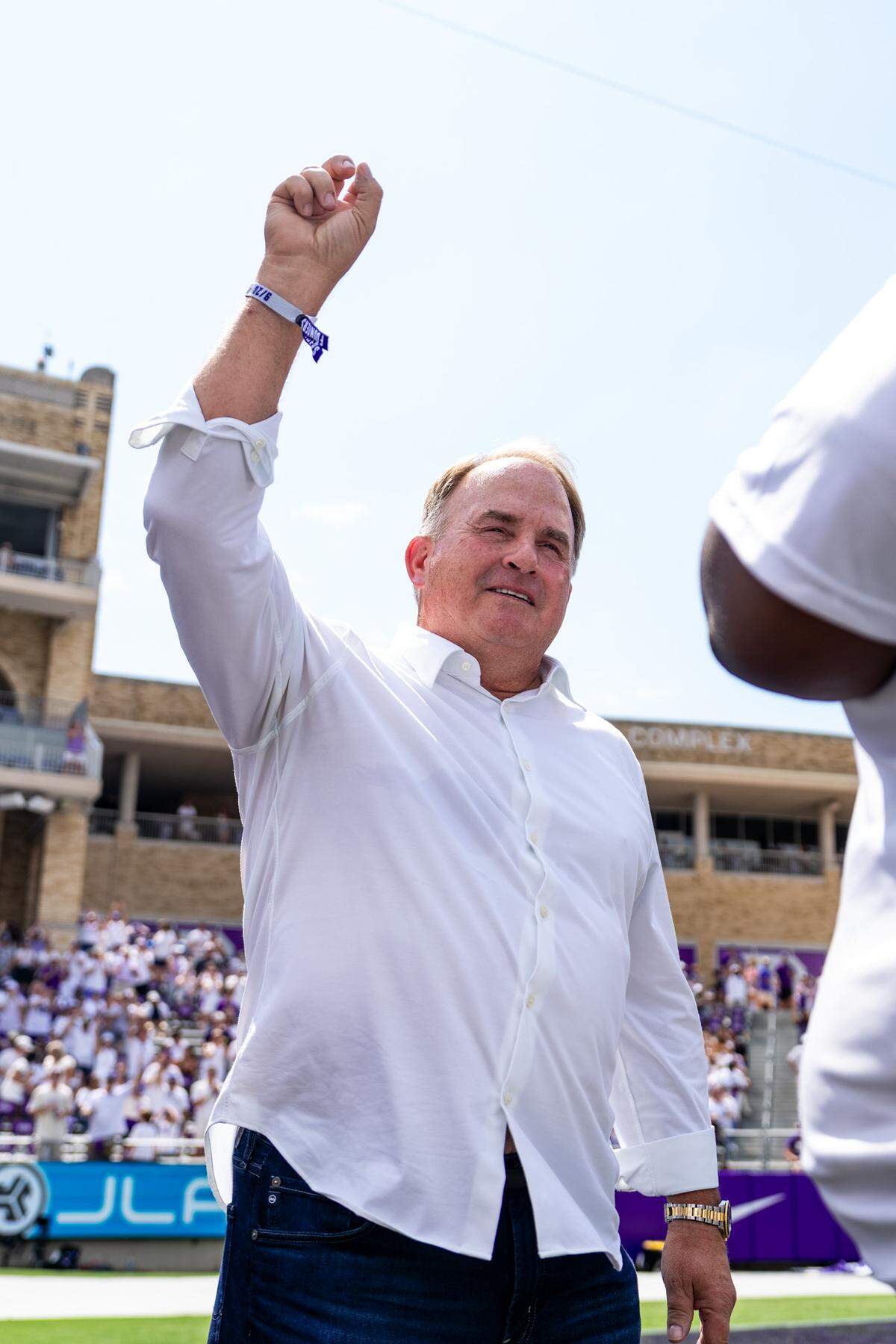 Former TCU head coach Gary Patterson throwing up a Go Frogs hand sign while being honored at halftime alongside seven other inductees into the TCU Hall of Fame during the team’s game against SMU at Amon G. Carter Stadium.