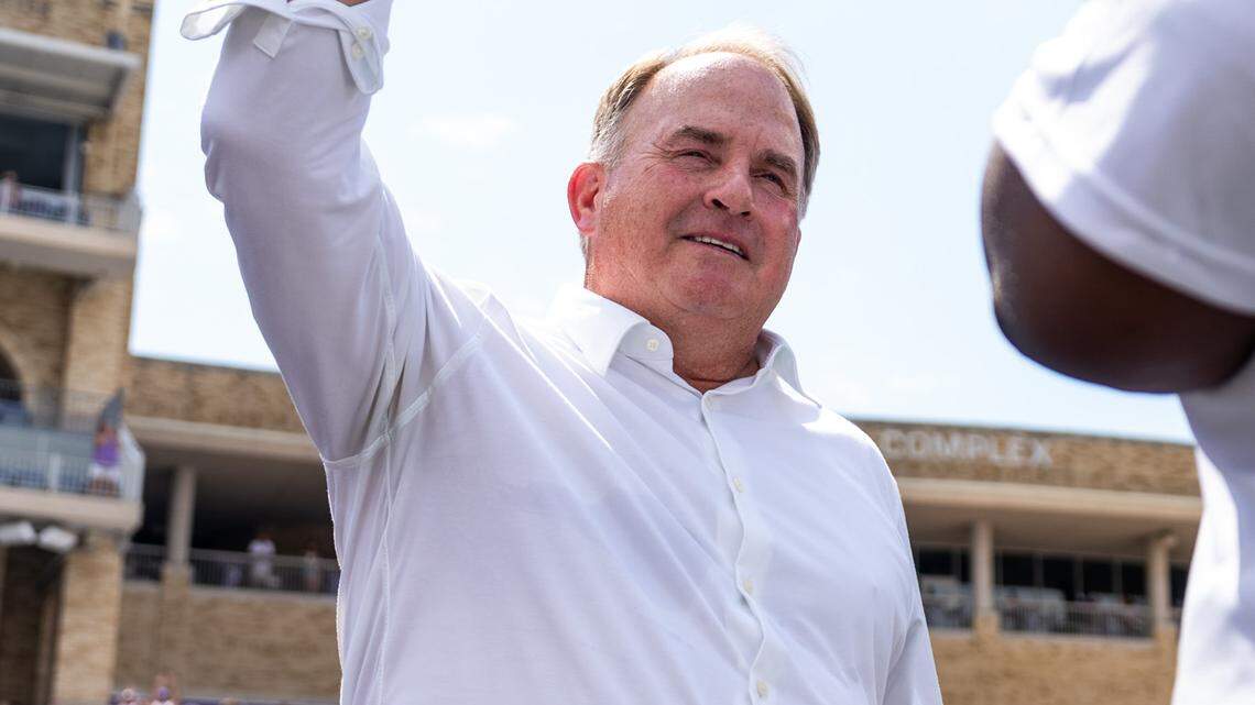 Former TCU head coach Gary Patterson throwing up a Go Frogs hand sign while being honored at halftime alongside seven other inductees into the TCU Hall of Fame during the team’s game against SMU at Amon G. Carter Stadium.