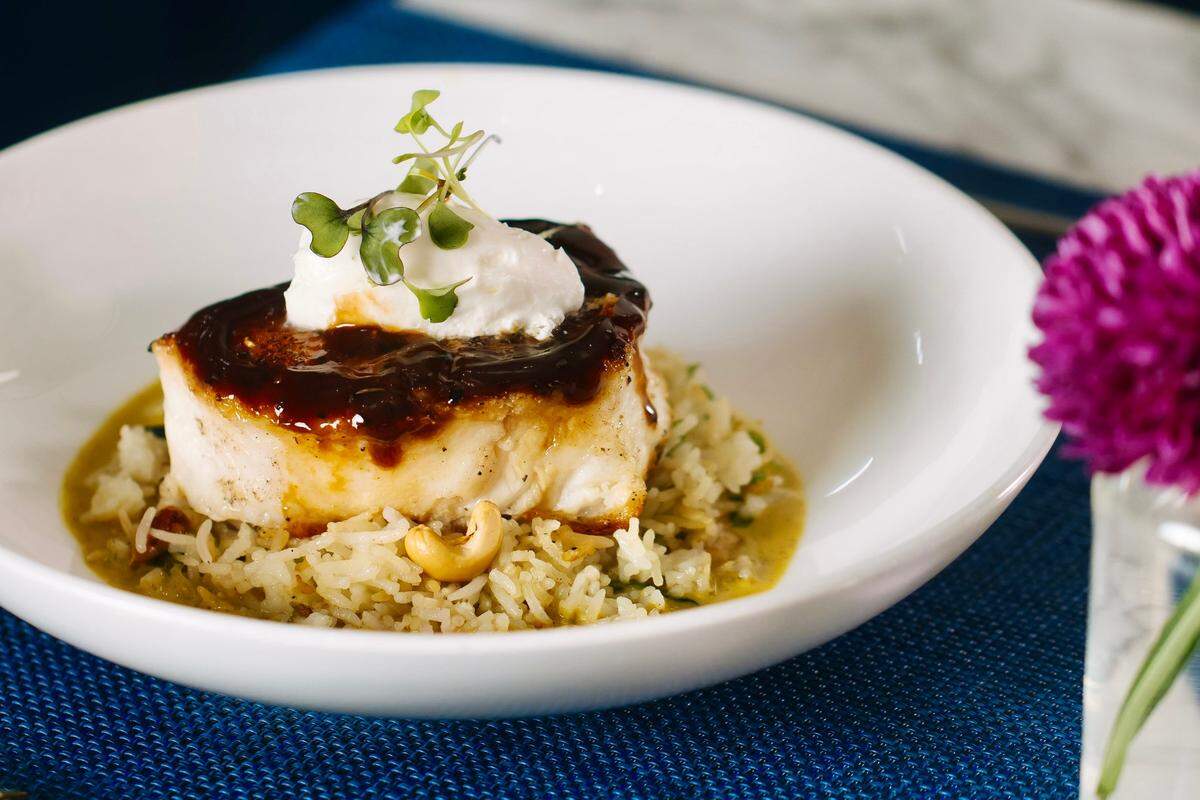 Ginger-miso Chilean sea bass witn rice, cashew and curry nage is one of five choices through Aug. 18 for Restaurant Week at Wicked Butcher in Fort Worth.
