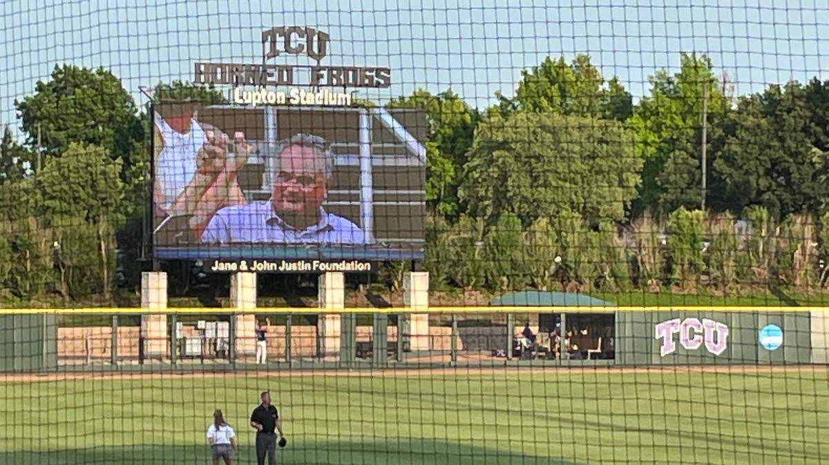 TCU head football coach Sonny Dykes takes in game two of the NCAA Super Regional at Lupton Stadium in Fort Worth. He was shown on the video board in left field.