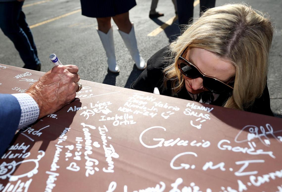 Fort Worth Mayor Mattie Parker signs her name to the final beam during a topping out ceremony for the Texas A&M-Fort Worth Law and Education Building currently under construction on Monday, Nov. 11, 2024.