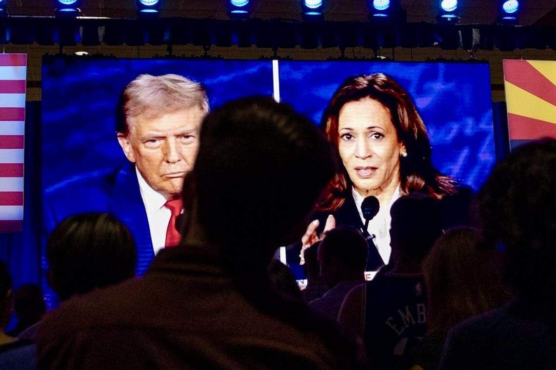 People at the Mesa Convention Center in Mesa, Arizona, watch former President Donald J. Trump and Vice President Kamala Harris debate on Sept. 10, 2024.