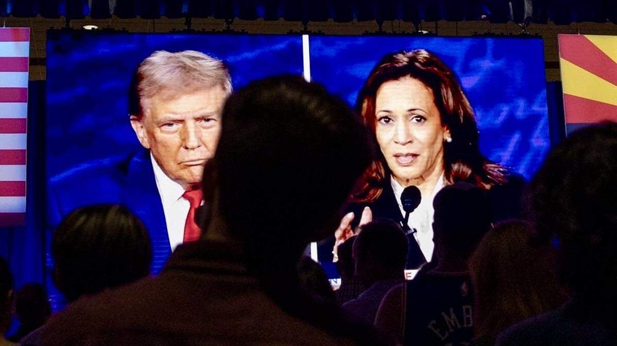People at the Mesa Convention Center in Mesa, Arizona, watch former President Donald J. Trump and Vice President Kamala Harris debate on Sept. 10, 2024.