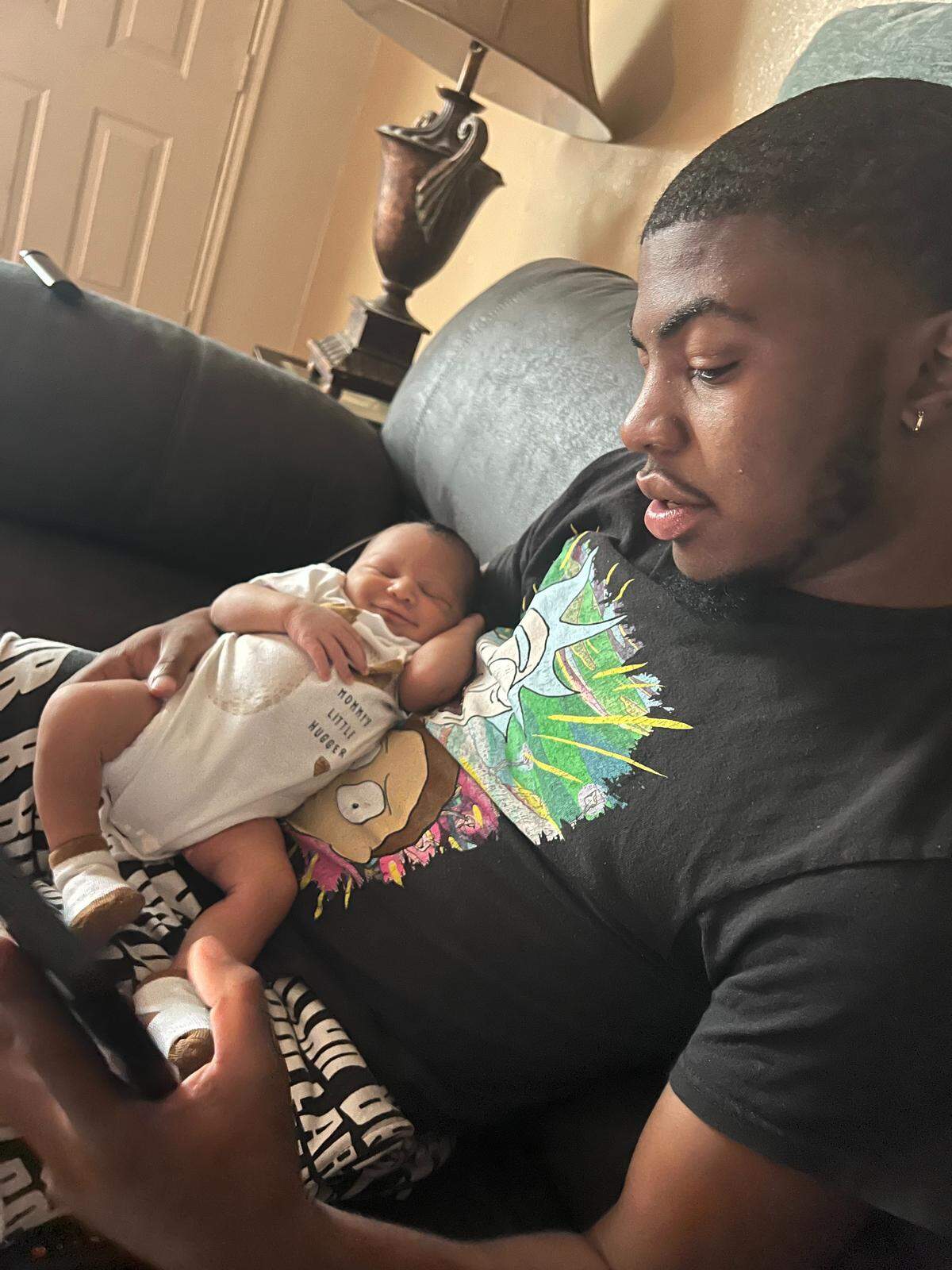 Darren Keith Stanley, Jr. with his son. Stanley died after being sent home from the hospital ER twice.