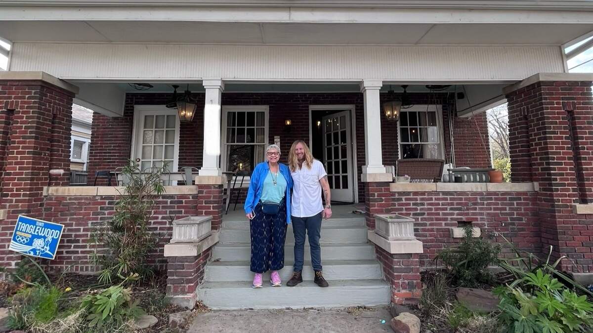 Rabbi Anne Brener, left, and Jamey Ice stand on the steps of his century-old home in the National Historic Neighborhood of Fairmount. Brener’s grandfather bought the house when it was new. Jamey Ice bought it in 2012 as an abandoned foreclosure.