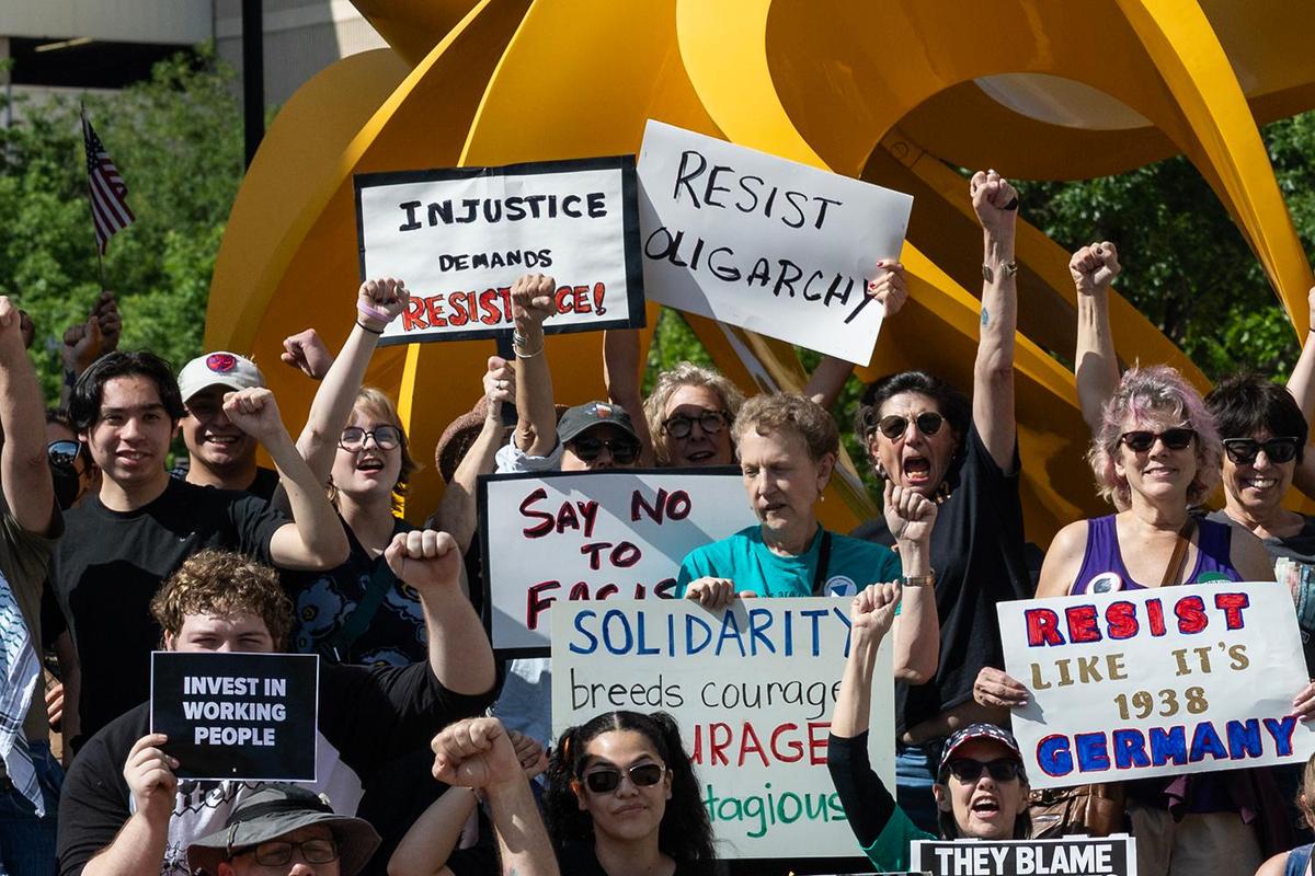 Protesters gather for the Fort Worth May Day 2025 Rally in Solidarity With Federal Workers at the Tabachin Ribbon sculpture in downtown Fort Worth on Thursday, May 1, 2025.
