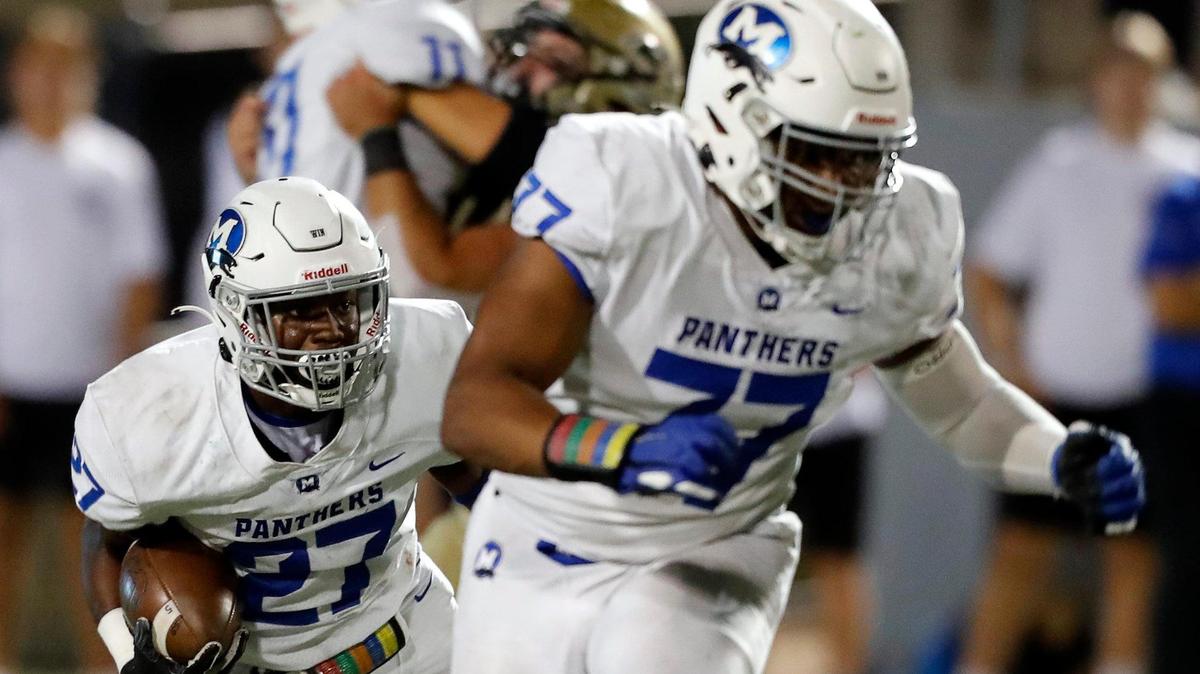 Midlothian running back Jordon Richburg (27) folows his blocker, lineman Tyler Ethridge (77), out of the backfield in a high school football game at Birdville Fine Arts/Athletic Complex in North Richland Hills, Texas, Friday, Sept. 24, 2021. Midlothian led 13-7 after one half of play in a district 4-5A Division I game. (Special to the Star-Telegram Bob Booth)