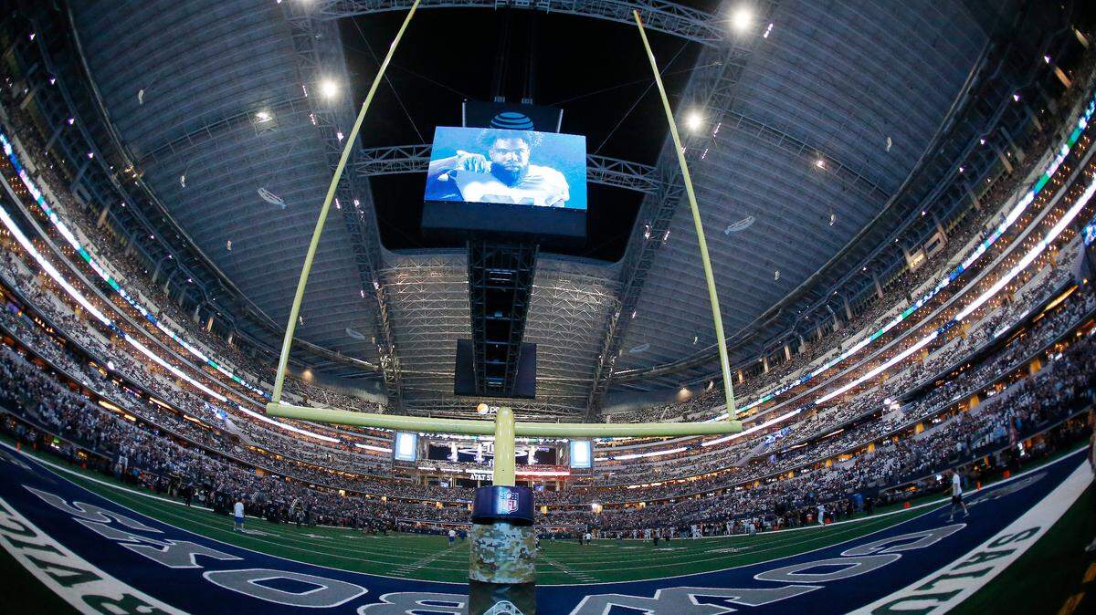 Fans watch the field before the first half of the Dallas Cowboys’ game against the Tennessee Titans at AT&T Stadium,