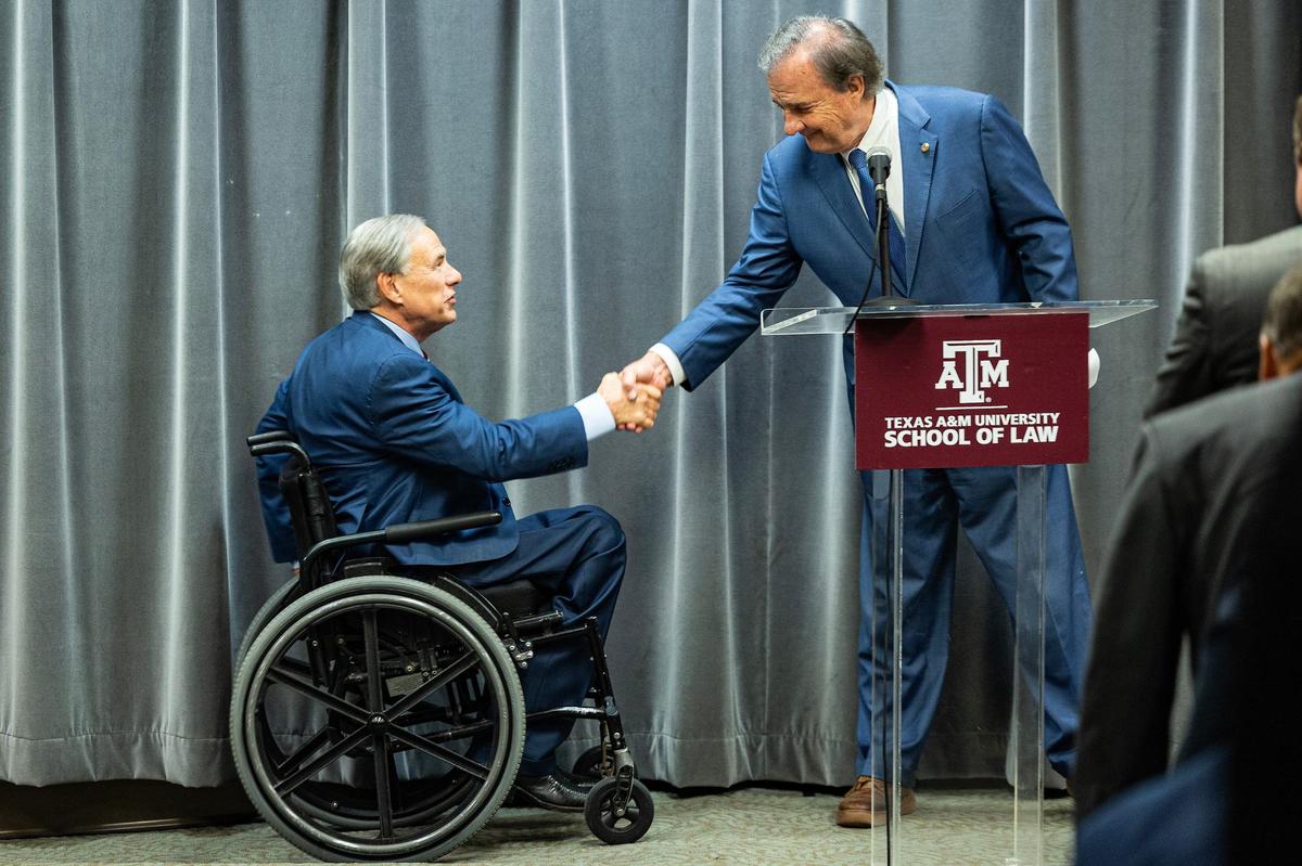 Texas Governor Greg Abbott shakes hands with Texas A&M Chancellor John Sharp prior to an official swearing in ceremony for the 10 Texas State Business Court Justices at the Texas A&M Law School in downtown Fort Worth on Thursday, Sept. 19, 2024.