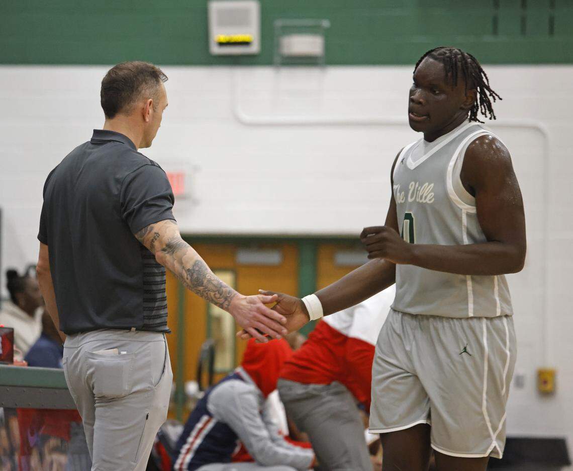 Birdville head coach Anthony Holman greets forward Gabriel Zachariah (0) as he comes of the court against Denton Ryan during the first half of a UIL basketball game at Birdville High School in North Richland Hills, Texas, Tuesday Feb. 17, 2026.
