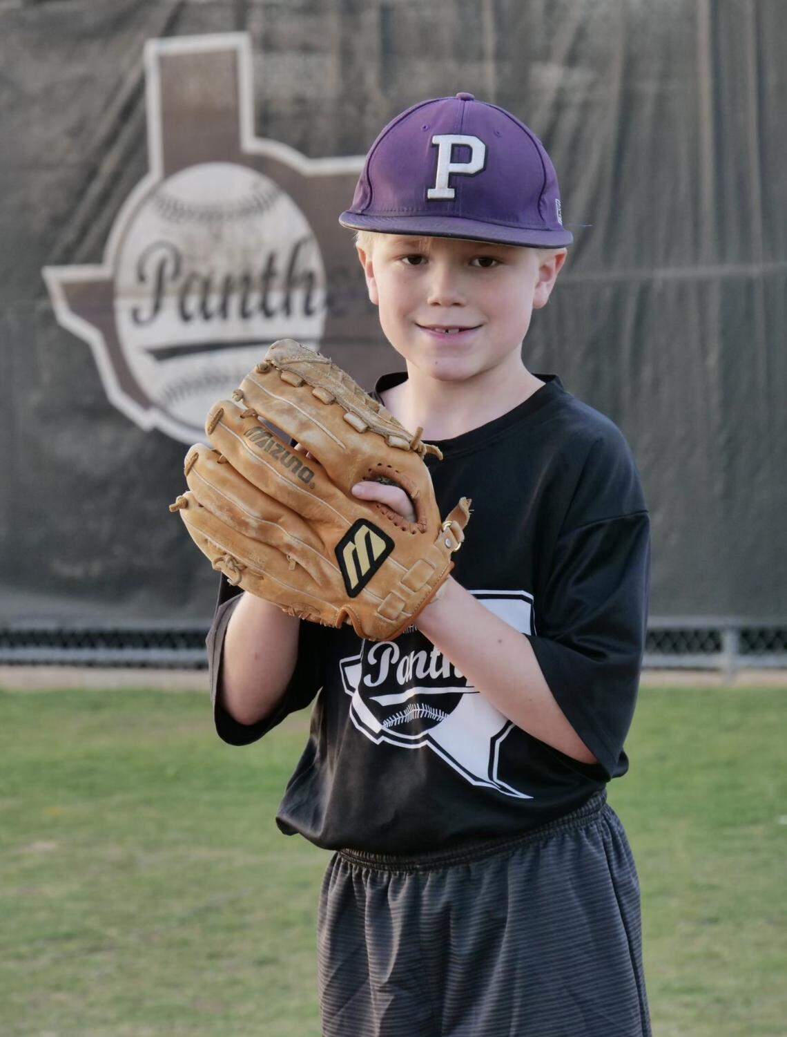 Cape Grant wears Drew Medford’s Paschal baseball hat as he prepares to throw the first pitch ahead of the final game of the Drew Medford Memorial Tournament.