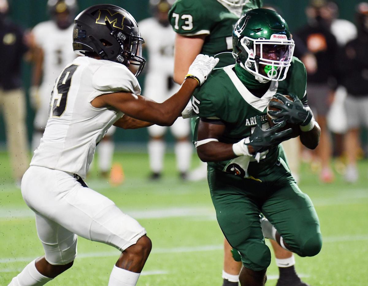Mansfield’s Kimani Johnson,left is unable to stop Arlington’s Rodney Talton as he goes in for the touchdown to take a 37-7 lead in the third quarter of their football game Friday, September 25, 2020 at Globe Life Park in Arlington, Texas. Special/Bob Haynes