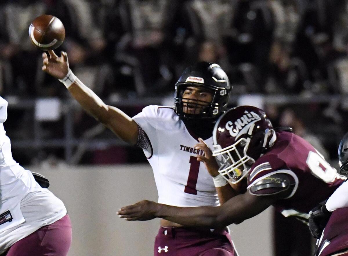 Mansfield Timberview quarterback Simeon Evans left, throws down the field as he is hit by Ennis’s Deryous Stokes in the second quater of their Division 2 Region 2-5A Area Play-off football game Friday, December 18, 2020 at the Midlothian ISD Mult-Purpose Stadium in Midlothian, Texas. Timberview won 42-28. Special/Bob Haynes