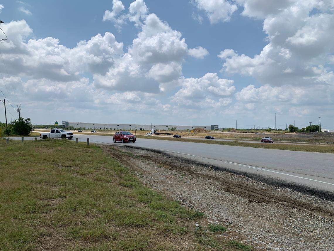 Vehicles turn off North Tarrant Parkway and head to Harmon Road as cars blaze northward along US 287 in the background. 