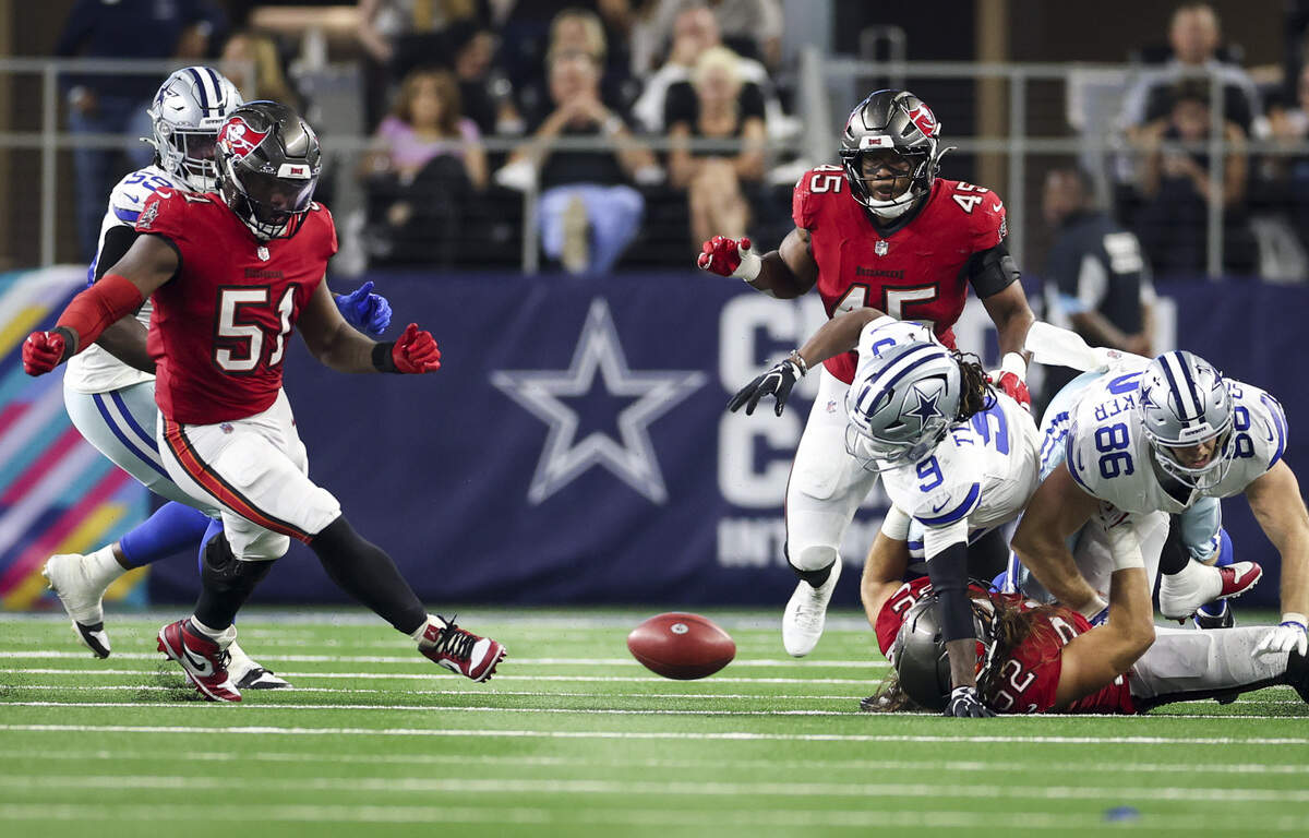 A Dallas Cowboys ball breaks loose and is recovered by the Tampa Bay Buccaneers during the second half of the game Thursday, Oct. 8, 2026, at AT&T Stadium in Arlington.