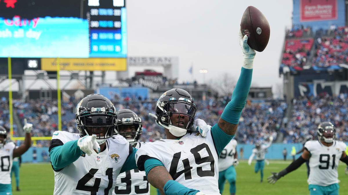 Jacksonville Jaguars defensive end Arden Key (49) celebrates a fumble recovery with Jacksonville Jaguars linebacker Josh Allen (41) and Jacksonville Jaguars linebacker Devin Lloyd (33) during an NFL football game against the Tennessee Titans on Sunday.