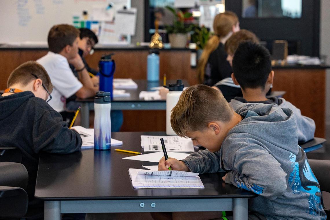A student takes notes in his first class of the day at McAnally Middle School on Thursday, Oct. 6, 2022, in Aledo. The Aledo Independent School District finished building the second middle school this year to support its growing student population.