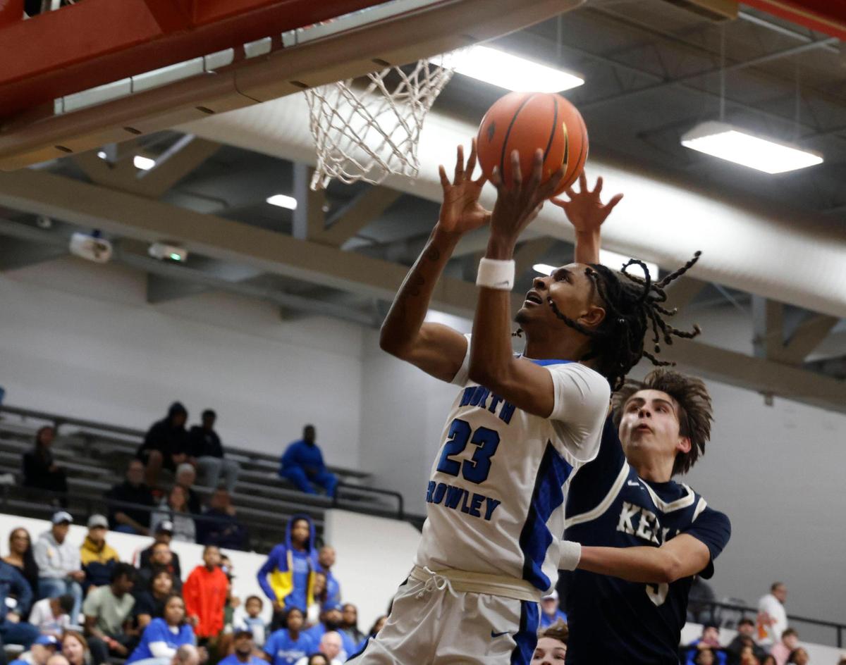 North Crowley forward Aiden Whitmore (23) puts in a left hander in front of Keller guard Evan Guerra (3) during the second half of the UIL 6A Region I Bi-District playoff game at Martin High School in Arlington, Texas, Monday, Feb. 17, 2025.