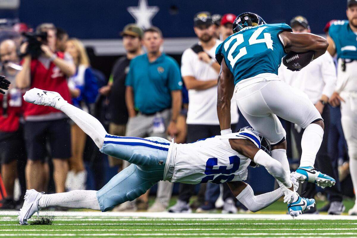 Dallas Cowboys corner back Myles Brooks (39) goes for a tackle on Jacksonville Jaguars running back Snoop Conner (24) in the third quarter at AT&T Stadium in Arlington, Texas on Saturday, Aug. 12, 2023.