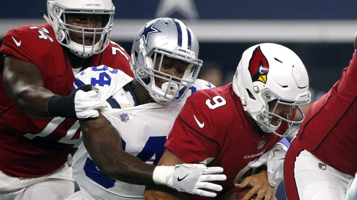 Arizona Cardinals quarterback Sam Bradford (9) is sacked by Dallas Cowboys defensive end Randy Gregory as Cardinals’ D.J. Humphries (74) defends in the first half of an preseason NFL football game in Arlington, Texas, Sunday, Aug. 26, 2018.