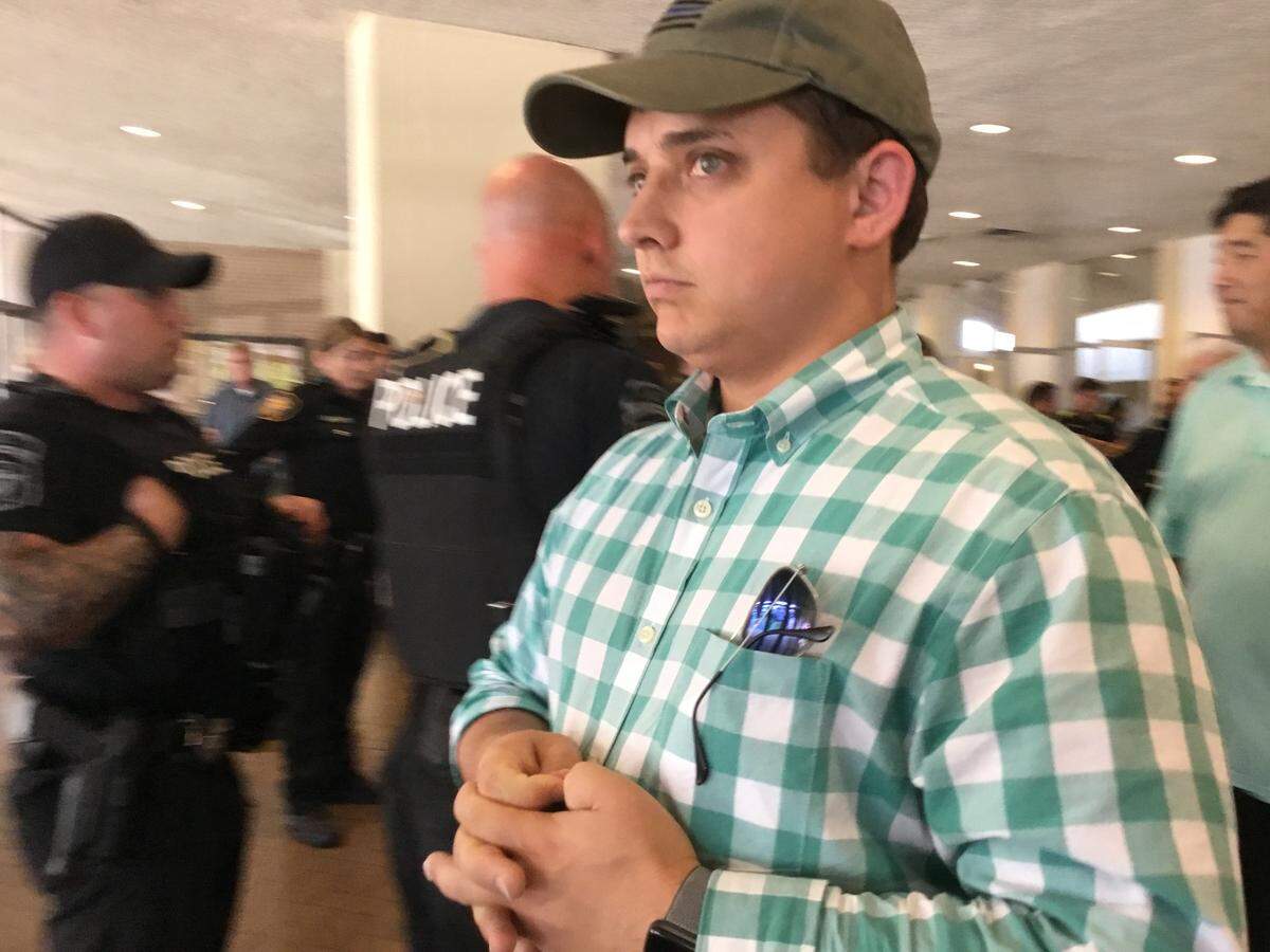 State Rep. Briscoe Cain, R-Deer Park, was removed from the 2018 state Democratic convention in the Fort Worth Convention Center over prank signs he distributed.