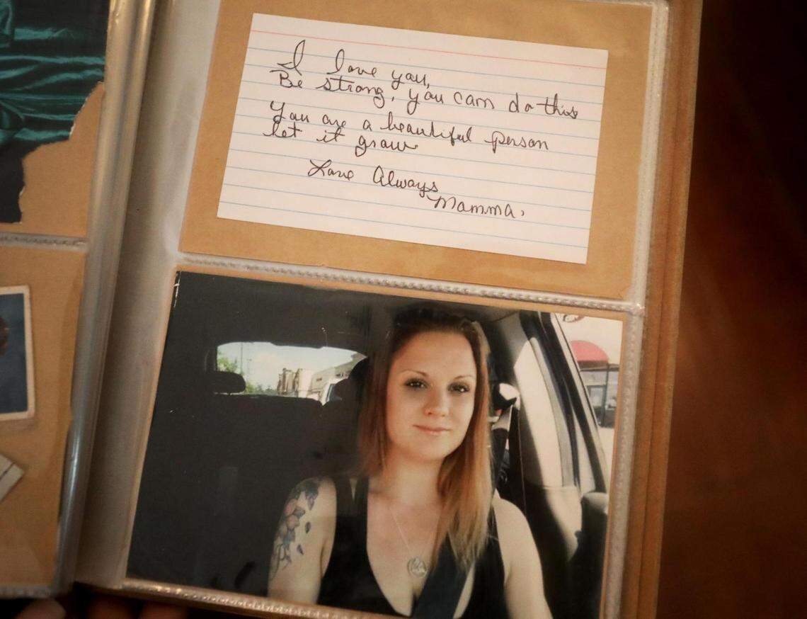 A page in a photo album shows a photograph of Lauren Phillips along with a note written to her from her mother, Kathie Phillips.