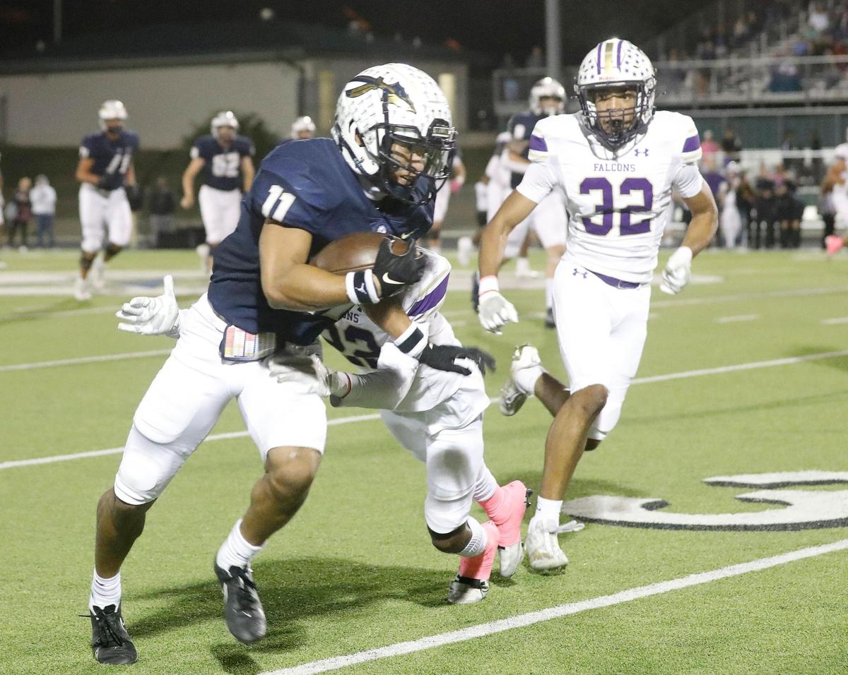 Keller wide receiver Amarion Henry (11) takes a short pass for yards defended by Timber Creek defensive back Antwan Bridges (22) and linebacker Tristan Armstrong (32) in the first half of a District 4-6A high school football game at Keller ISD Stadium in Keller, Texas, Thursday, Oct. 27, 2022. Keller led Timber Creek 20-3 at the half. (Special to the Star-Telegram Bob Booth)