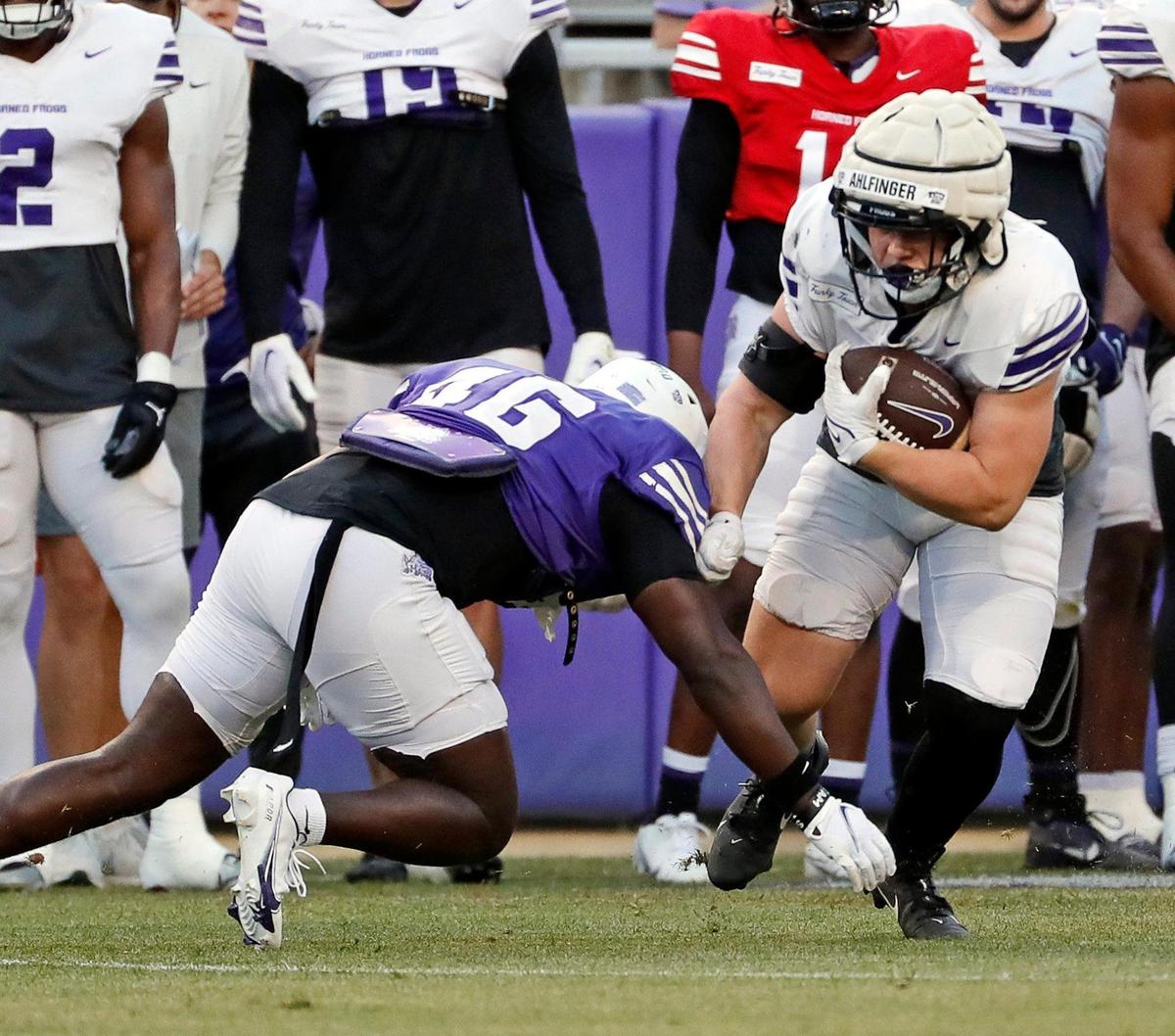 TCU safety Daveion Crawford (46) contains running back Brant Ahlfinger (24) during the TCU Spring Game at Amon G. Carter Stadium in Fort Worth, Texas, Friday, Apr. 14, 2023. (Special to the Star-Telegram Bob Booth)
