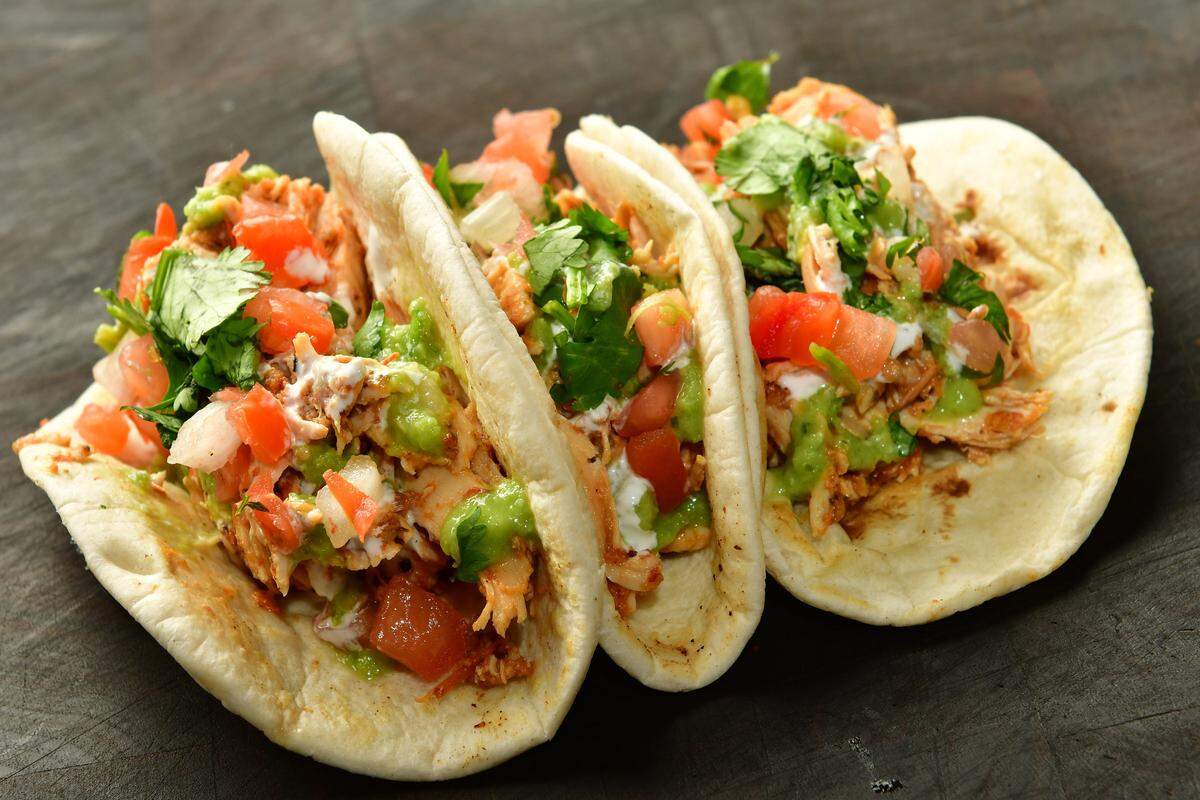 Salsa chicken tacos at AT&T Stadium:  Chicken breast marinated and cooked in fresh charred red salsa and topped with sour cream sauce, spicy tomatillo avocado salsa, chopped cilantro and pico de gallo.