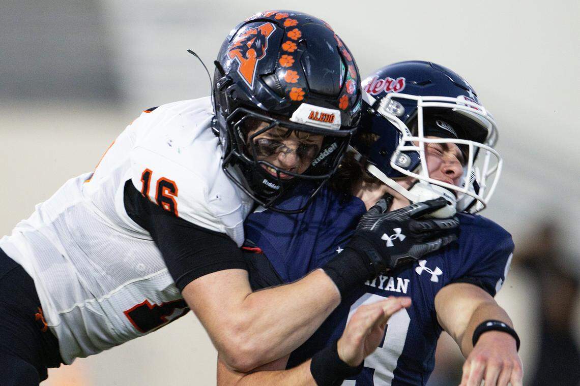 Denton Ryan quarterback Quin Henigan (9) is tackled by Aledo linebacker Cole Cox (16) for a safety in the first half of a high school football game between the Aledo Bearcats and the Denton Ryan Raiders at C.H. Collins Athletic Complex in Denton on Friday, Oct. 3, 2025. 