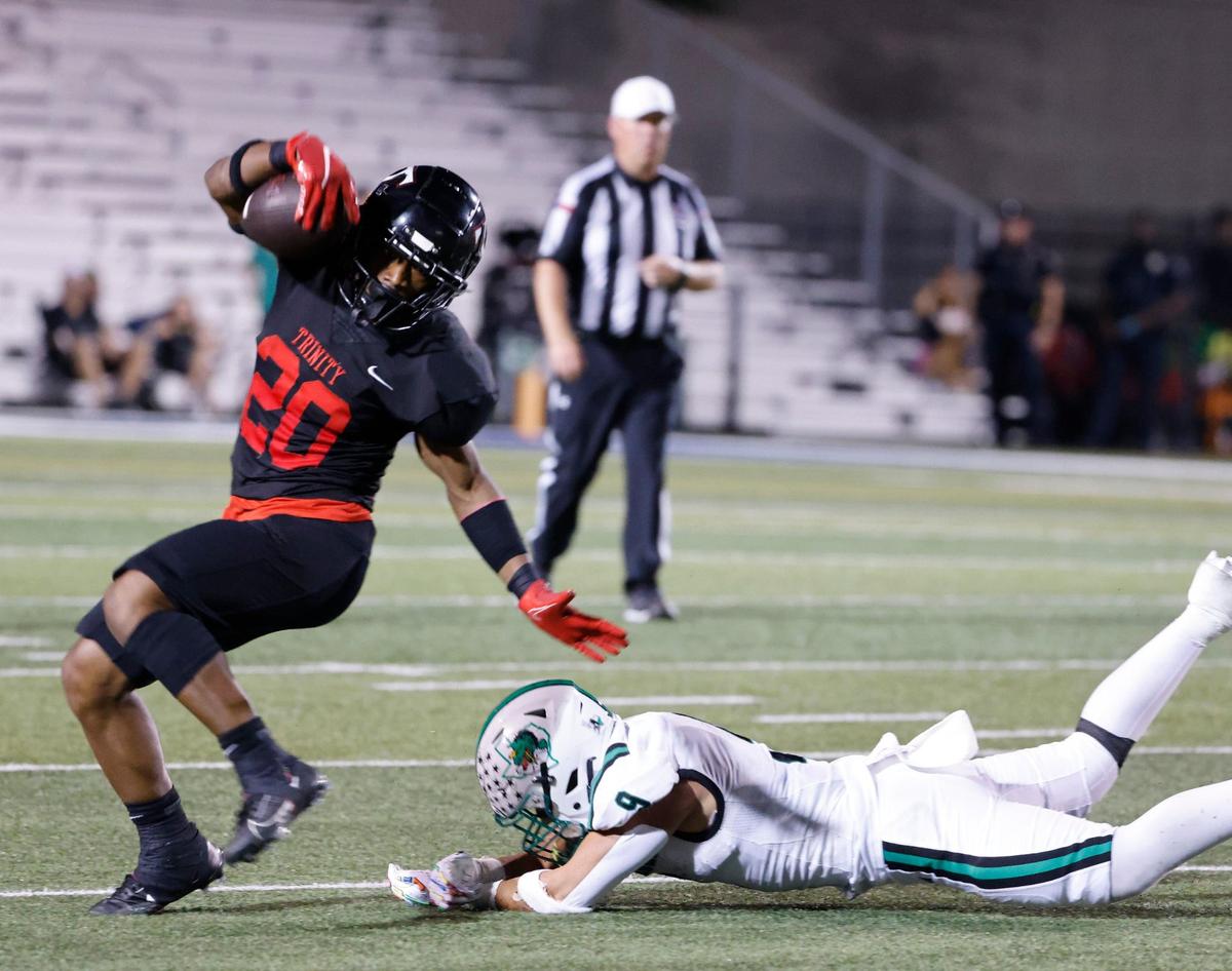 Trinity running back Joshua Bell (20) side steps Southlake defensie back William Chen (9) during a UIL 6A Conference football game at Pennington Field in Bedford Texas, Friday, Sept. 20, 2024.