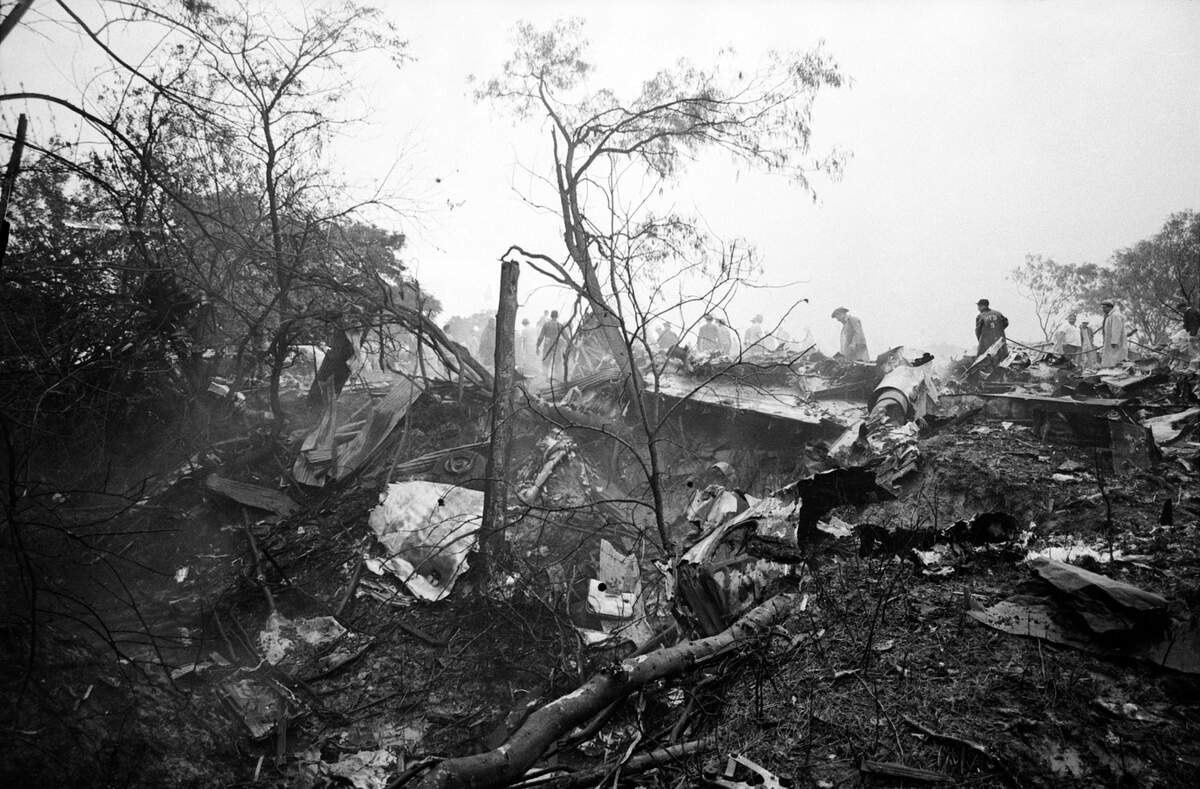  Pictured are rescue workers attempting to sift through wreckage of the plane. 